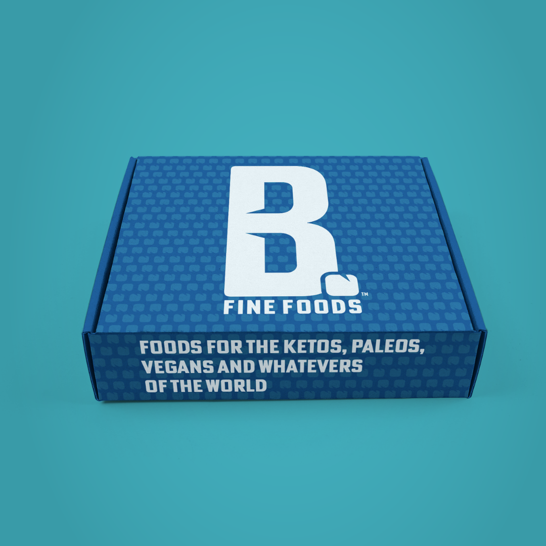 B Fine Foods Box with logo and "Foods for Ketos, Paleos, Vegans, and Whatevers of the World"