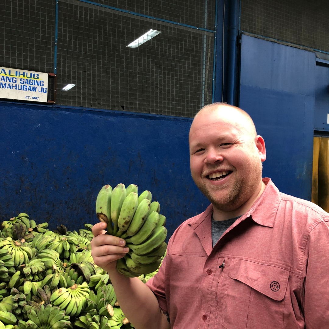 Jared at market holding saba bananas