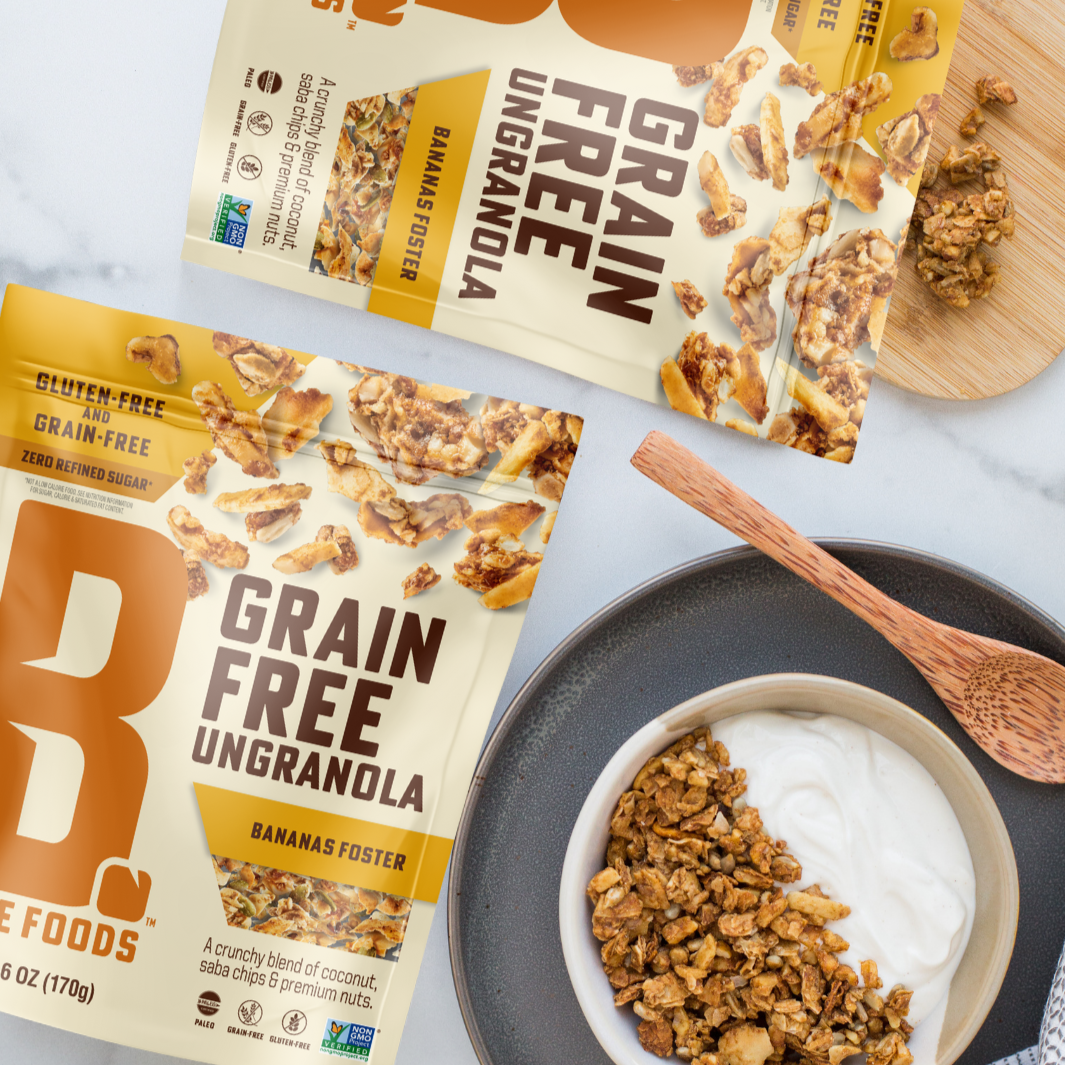 Bananas Foster Bags next to a bowl of Yogurt and spoon with the Grain Free UnGranola in the bowl